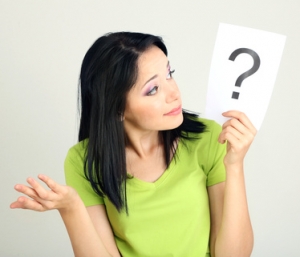 Woman with question marks on grey background